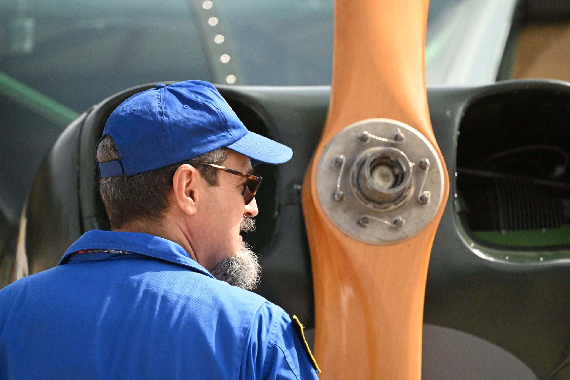 Maintenance technician inspecting a piston aircraft propeller